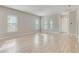 Spacious living room featuring large windows and light hardwood floors at 7789 Nemours Pkwy, Orlando, FL 32827