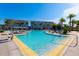 Inviting bright pool with lounge chairs, umbrellas, and seating area perfect for relaxation at 7789 Nemours Pkwy, Orlando, FL 32827