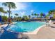 Resort-style pool with palm trees, lounge chairs, and water features offers a relaxing outdoor space at 7789 Nemours Pkwy, Orlando, FL 32827