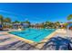 A bright pool with lounge chairs and palm trees provides ample room to relax in the sun at 7789 Nemours Pkwy, Orlando, FL 32827
