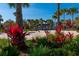 Beach volleyball court near lush greenery and palm trees, perfect for outdoor fun at 7789 Nemours Pkwy, Orlando, FL 32827