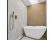 Close-up of a luxurious soaking tub with gold hardware and marble accents at 7813 Delphia St, Orlando, FL 32807