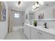 Elegant bathroom featuring a double vanity, marble floors, and shower with curtain at 7813 Delphia St, Orlando, FL 32807