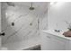 Modern bathroom featuring a spacious shower with a marble tile surround and dual shower heads at 7813 Delphia St, Orlando, FL 32807