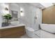 Modern bathroom with walk-in shower, soaking tub, and stylish vanity at 7813 Delphia St, Orlando, FL 32807