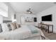 Bright bedroom featuring a kitchenette, television, ceiling fan, and stylish decor at 7813 Delphia St, Orlando, FL 32807