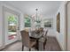Inviting dining area with modern chandelier, wood floors, and natural light at 7813 Delphia St, Orlando, FL 32807