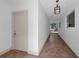 Hallway with tile flooring, brick wall, and view of backyard at 7813 Delphia St, Orlando, FL 32807