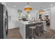 Modern kitchen with stainless steel appliances, an island with seating, and sleek white cabinets at 7813 Delphia St, Orlando, FL 32807