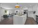 Bright, well-appointed kitchen with island seating and modern decor flows into the living space at 7813 Delphia St, Orlando, FL 32807
