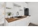 Modern kitchenette with butcher block counters and stainless steel appliances at 7813 Delphia St, Orlando, FL 32807