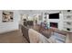 Bright living room featuring an open floor plan, fireplace, and modern decor with natural wood flooring at 7813 Delphia St, Orlando, FL 32807