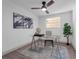 Bright office space with glass desk, ceiling fan, and modern artwork at 7813 Delphia St, Orlando, FL 32807