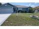 Charming single-story home boasts a well-manicured lawn, mature landscaping, and a two-car garage at 8187 Sw 60Th Ter, Ocala, FL 34476