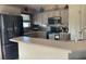 Well-equipped kitchen featuring modern stainless steel appliances, stylish backsplash, and breakfast bar seating at 8187 Sw 60Th Ter, Ocala, FL 34476