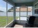 Inviting screened porch with view of the backyard and white fence, perfect for relaxation at 8187 Sw 60Th Ter, Ocala, FL 34476