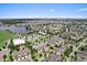 Aerial view of a residential community with a lake, well-maintained landscaping, and picturesque surroundings at 8436 Tavistock Lakes Boulevard, Orlando, FL 32827