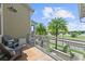 Relaxing balcony with chairs, palm trees, and scenic neighborhood views at 8436 Tavistock Lakes Boulevard, Orlando, FL 32827