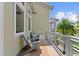 Charming balcony with outdoor seating, a neutral rug, and views of the surrounding lush landscape at 8436 Tavistock Lakes Boulevard, Orlando, FL 32827