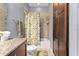 Bathroom showcases a shower-tub combination with a stylish leaf-themed shower curtain at 8436 Tavistock Lakes Boulevard, Orlando, FL 32827