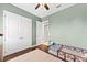 View of a bedroom with hardwood floors, ceiling fan and closet at 8436 Tavistock Lakes Boulevard, Orlando, FL 32827