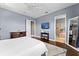 Bedroom boasts a large window, hardwood floors, and an en-suite bathroom at 8436 Tavistock Lakes Boulevard, Orlando, FL 32827