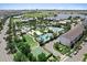 Aerial view of a resort style community pool with lush landscaping, basketball court, and lake at 8436 Tavistock Lakes Boulevard, Orlando, FL 32827