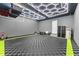 Well-organized garage featuring custom lighting, a durable floor, and ample storage space for tools and equipment at 8436 Tavistock Lakes Boulevard, Orlando, FL 32827