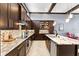 Well-equipped kitchen featuring granite countertops, stainless steel appliances, and ample storage space, perfect for cooking at 8436 Tavistock Lakes Boulevard, Orlando, FL 32827