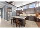 Stylish kitchen with stainless steel appliances, a marble island with seating, and dark wood cabinetry at 8436 Tavistock Lakes Boulevard, Orlando, FL 32827