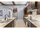 Modern kitchen with granite countertops, stainless steel appliances, and a mosaic backsplash, showcasing stylish design at 8436 Tavistock Lakes Boulevard, Orlando, FL 32827