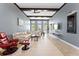 Spacious living room with a high ceiling, large windows, and a comfortable seating area, creating an airy atmosphere at 8436 Tavistock Lakes Boulevard, Orlando, FL 32827