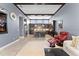 Bright living room and modern kitchen with a granite island, stainless steel appliances, and a cozy seating area at 8436 Tavistock Lakes Boulevard, Orlando, FL 32827