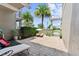 Private courtyard patio with pavers, bench seating, shade, and lush landscaping at 8436 Tavistock Lakes Boulevard, Orlando, FL 32827