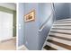 Staircase with wooden treads and white risers and handrail, leading to the upper level of the home at 8436 Tavistock Lakes Boulevard, Orlando, FL 32827