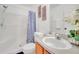 Bright bathroom with a shower and tub combination and a blue patterned shower curtain at 941 Clear Creek Cir, Clermont, FL 34714