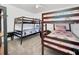 Bedroom with two sets of wooden bunk beds with colorful bedding and decor, plus neutral carpeting at 941 Clear Creek Cir, Clermont, FL 34714