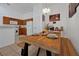 Dining area features wood table and bench, light fixture, and tile floors at 941 Clear Creek Cir, Clermont, FL 34714