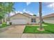 Charming single-story home featuring a two-car garage and well-maintained lawn at 941 Clear Creek Cir, Clermont, FL 34714