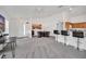 Open living area with neutral carpet, white walls, dining area, and breakfast bar at 941 Clear Creek Cir, Clermont, FL 34714