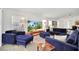 Cozy living room with dark blue furniture, large TV and bright natural light at 941 Clear Creek Cir, Clermont, FL 34714