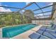 Screened-in pool with lounge chairs and hot tub offers a relaxing backyard retreat at 941 Clear Creek Cir, Clermont, FL 34714