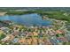 Aerial view of a community featuring homes with well-maintained lawns and a scenic lake at 9836 Lake District Ln, Orlando, FL 32832