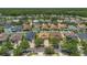 Community view with single Gathering homes, many trees, and lawns at 9836 Lake District Ln, Orlando, FL 32832