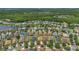 An aerial view of a neighborhood with well-maintained homes, lawns, and a peaceful lake at 9836 Lake District Ln, Orlando, FL 32832