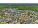 Aerial view of a neighborhood with well-manicured lawns, mature trees, and a serene lake at 9836 Lake District Ln, Orlando, FL 32832