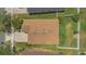 Aerial view of a well-maintained home with a brown roof, green lawn, and paved driveway at 9836 Lake District Ln, Orlando, FL 32832