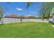 Large, green backyard enclosed by a white fence providing privacy and space for outdoor activities at 9836 Lake District Ln, Orlando, FL 32832