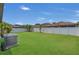 Extensive backyard with healthy green lawn, white fence, and room for entertainment and relaxation at 9836 Lake District Ln, Orlando, FL 32832