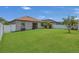 Expansive backyard featuring lush green grass, white fence, and an inviting outdoor space at 9836 Lake District Ln, Orlando, FL 32832